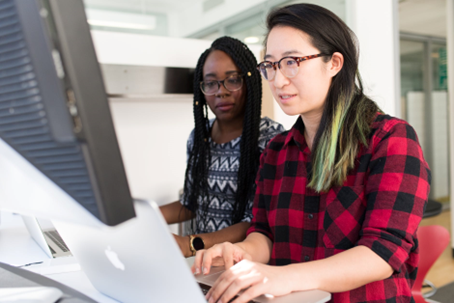 Two Coworkers looking at a laptop